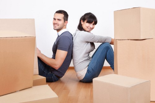 Happy family unloading a removal truck in Tooting